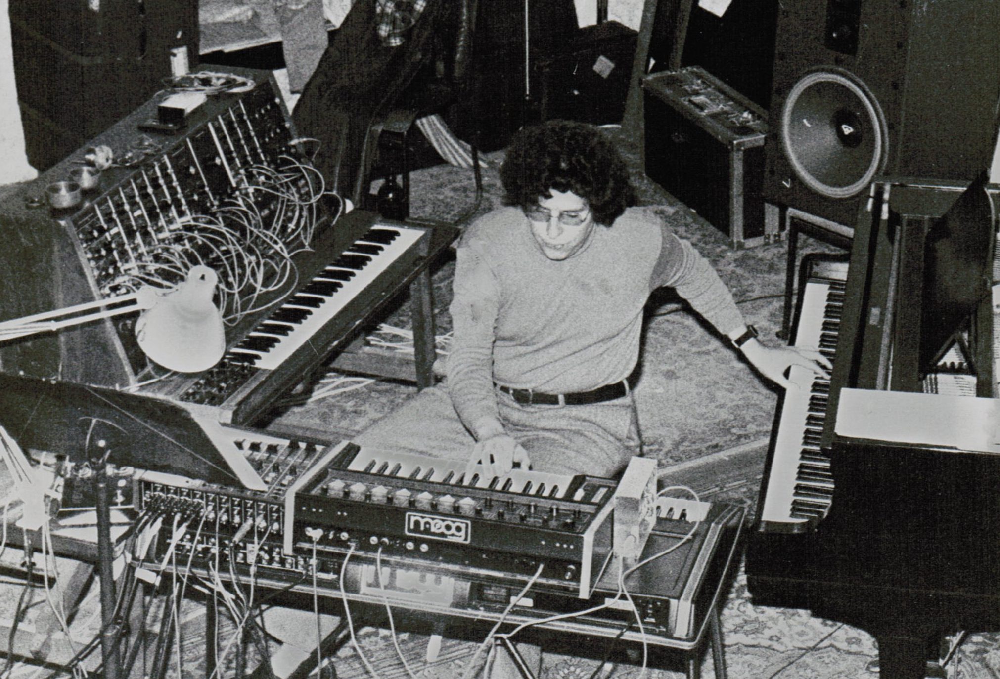 A man plays numerous synthesizers